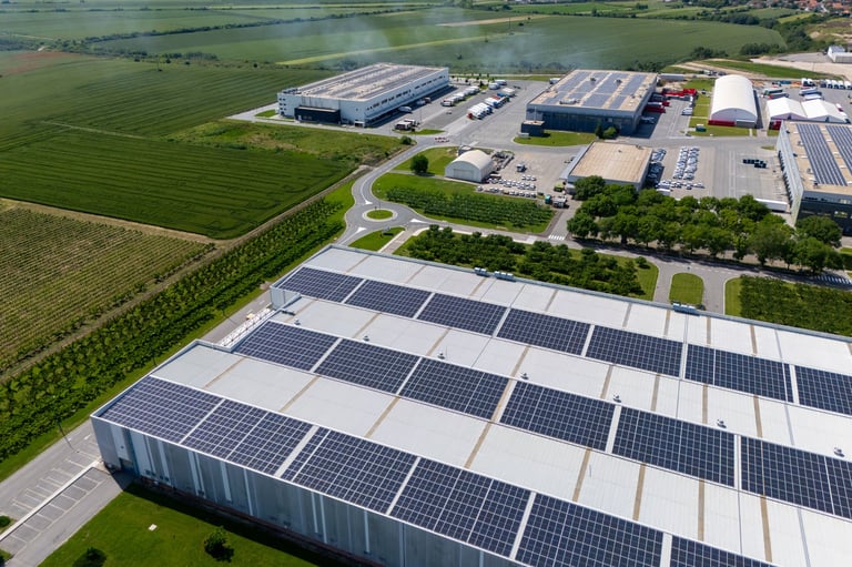 Aerial view of a modern logistics center with solar panels on the roof